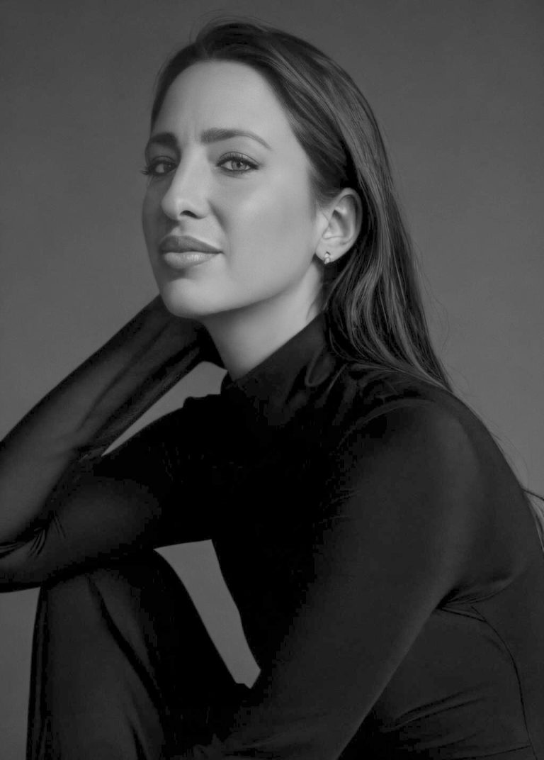 Retrato en blanco y negro de Cristina Bejarano, artista y diseñadora de esculturas urbanas, con expresión serena y elegante, vestida con top negro de manga larga.